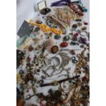 A large quantity of costume jewellery including brooches,