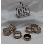 An Edward VII Silver toast rack with four divisions on ball feet, Sheffield, 1906,