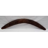 An Aboriginal boomerang with chip carved decoration of emus and kangaroos, 54.