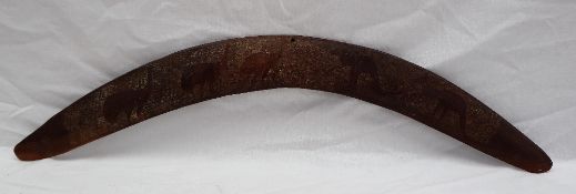 An Aboriginal boomerang with chip carved decoration of emus and kangaroos, 54.