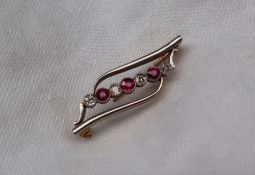 A ruby and diamond bar brooch,