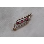 A ruby and diamond bar brooch,