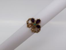 A suffragette type ring, set with citrines, amethysts and an emerald,