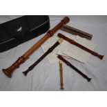 A Dolmetsch Bass recorder together with a collection of Dolmetsch recorders,