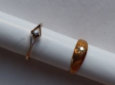 A yellow metal ring, set with an old round cut diamond, marked 15ct, size K,