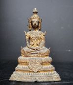 A gilt bronze figure of a seated buddha, on a stepped base, 18.