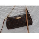 A small Louis Vuitton monogram clutch bag, with a leather shoulder strap,