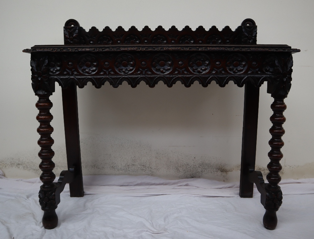 A 19th century carved oak side table, the raised back carved with arched and flowers heads, - Image 3 of 9