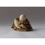 A 19th century Japanese ivory netsuke, depicting Fukurokuju with a turtle,