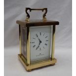 A modern carriage clock, the white dial with Roman numerals inscribed Matthew Norman,