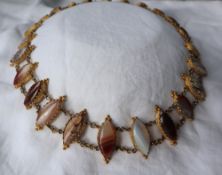 A Victorian gilt metal and hardstone set necklace, with pointed oval banded agates, on chain links,