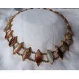 A Victorian gilt metal and hardstone set necklace, with pointed oval banded agates, on chain links,