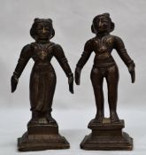 A pair of Indian bronze figurines in traditional dress on square bases,
