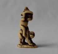 A 19th century Japanese bone netsuke depicting two monkey,