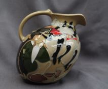 A Moorcroft pottery jug, decorated in the "Pigalle" pattern,