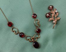 A 9ct yellow gold garnet set necklace,