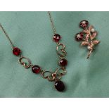 A 9ct yellow gold garnet set necklace,