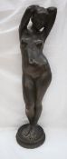 An Elizabeth Anne Clapp plaster figure of a nude, standing with her arms above her head,