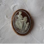 A shell cameo brooch depicting an allegorical scene to a 9ct yellow gold setting,