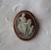 A shell cameo brooch depicting an allegorical scene to a 9ct yellow gold setting,