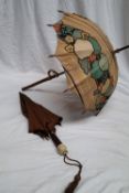 A carved bamboo handled parasol together with an ivory,