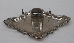 An Edward VII Silver desk standish, of pointed form, the edge moulded with leaves,