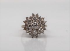 A diamond cluster ring, set with three tiers of round brilliant cut diamonds,