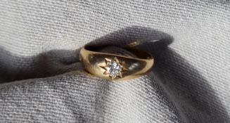 An 18ct gold ring, set with a round old cut diamond, size L, approximately 3.