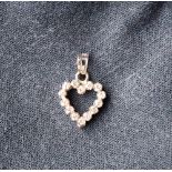 An 18ct white gold heart set with fourteen round brilliant cut diamonds each approximately 0.