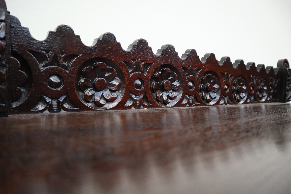 A 19th century carved oak side table, the raised back carved with arched and flowers heads, - Image 6 of 9