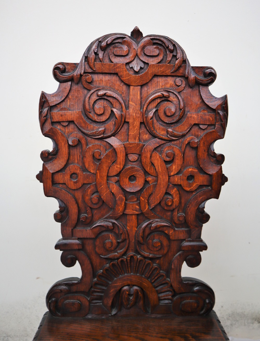 A pair of continental carved oak hall chairs, the back decorated with scrolling leaves and a shell, - Image 3 of 11