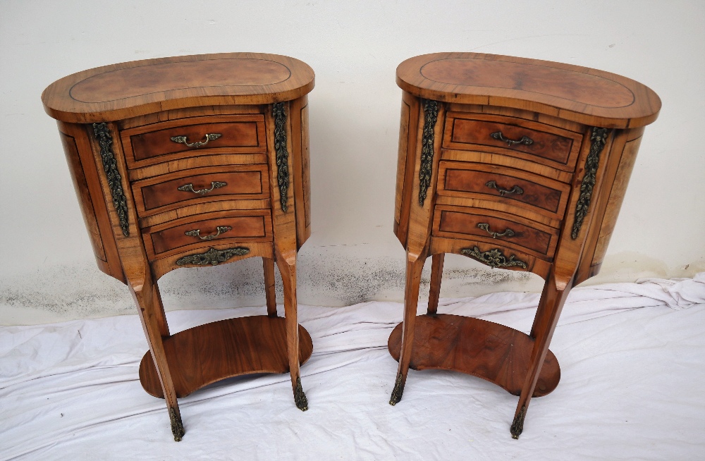A pair of continental kidney shaped walnut side tables,