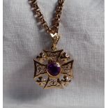 A yellow metal pendant in the shape of a pierced Maltese Cross,