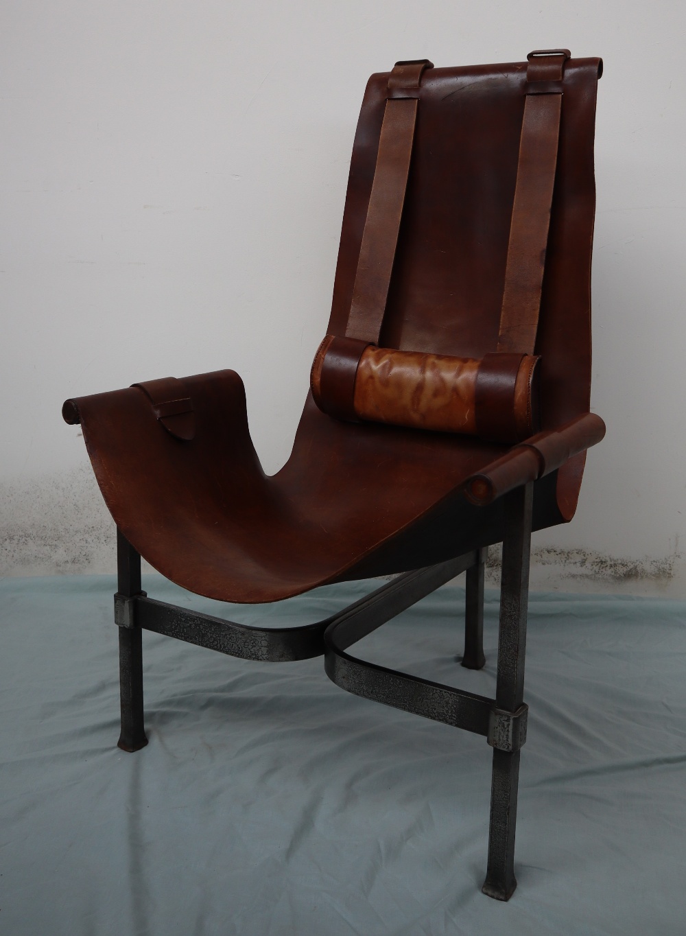 A 20th century leather and wrought iron elbow chair,