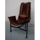 A 20th century leather and wrought iron elbow chair,