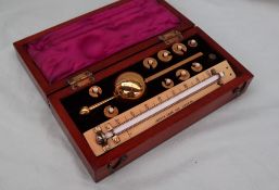 A Sikes's hydrometer, with weights and Joseph Long thermometer,