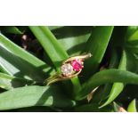 A ruby and diamond crossover ring, set with an old round cut diamond approximately 0.