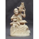 A 19th century Japanese ivory carving of a fisherman, seated upon a basket with birds to his side,