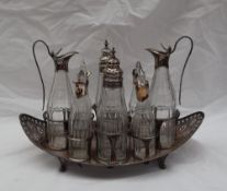 A George III Old Sheffield plate boat shaped cruet stand, with pierced ends and eight glass bottles,