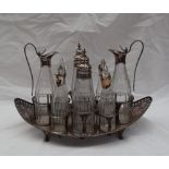 A George III Old Sheffield plate boat shaped cruet stand, with pierced ends and eight glass bottles,