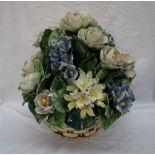 A Continental pottery basket of flowers and leaves,