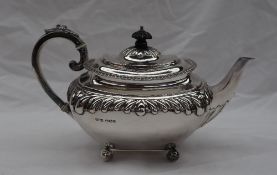 A Victorian silver teapot, with a domed cover and gadrooned edge, with a leaf capped handle,