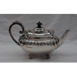 A Victorian silver teapot, with a domed cover and gadrooned edge, with a leaf capped handle,