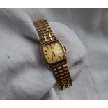 A Lady's 9ct yellow gold Omega De Ville wristwatch, the gilt rectangular dial with batons,