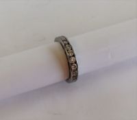A diamond half eternity ring set with seven round brilliant cut diamonds totalling approximately 0.