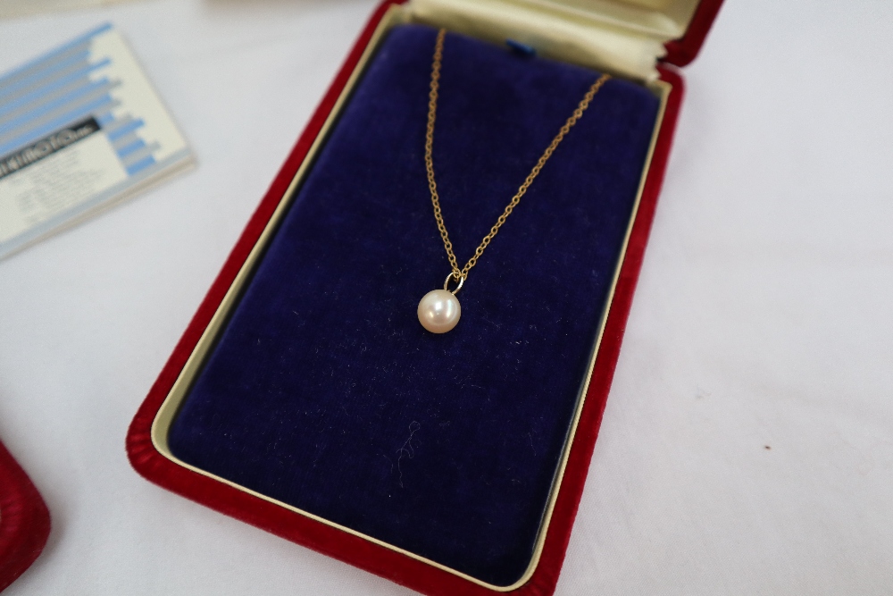 A Mikimoto pearl pendant on a 14ct gold suspension loop on a yellow metal chain, - Image 2 of 5