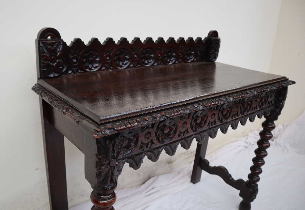 A 19th century carved oak side table, the raised back carved with arched and flowers heads, - Image 4 of 9