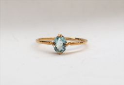 An aquamarine ring, the oval faceted aquamarine to a yellow metal setting and shank, size Q,