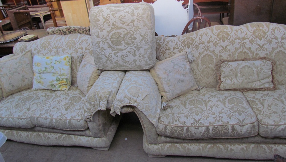 A pair of floral upholstered three seater settees together with a foot stool