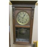 An early 20th century oak wall clock,